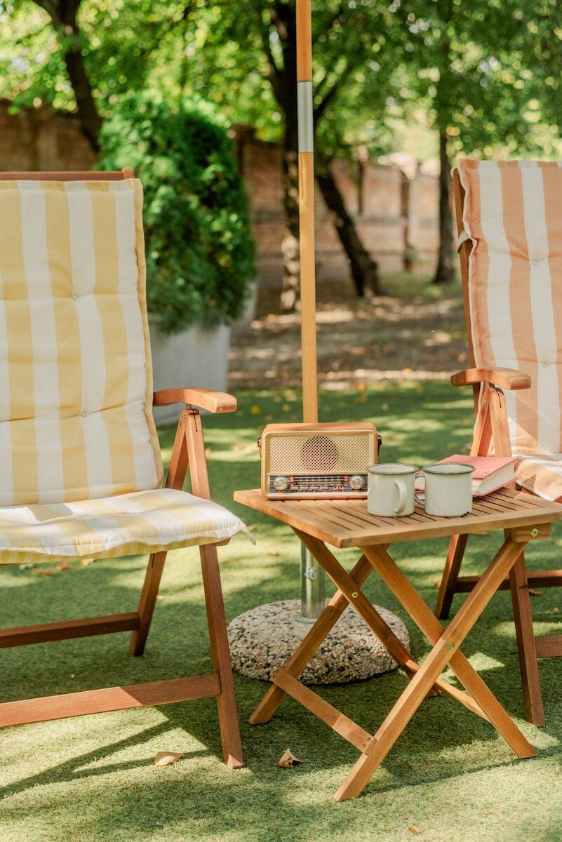 A couple of lawn chairs sitting under an umbrella